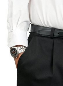 Man wearing a watch with his hand in his suit pocket
